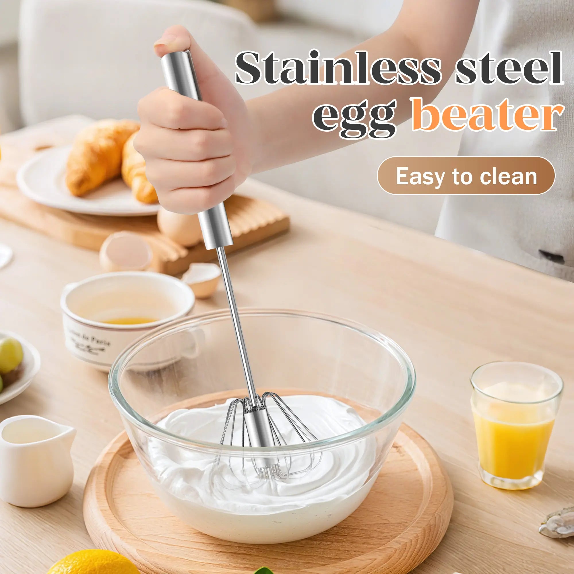 Hand-push stainless steel rotary whisk mixing ingredients in a glass bowl